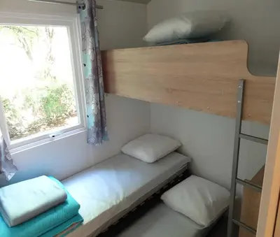 Un ou plusieurs lits dans un hébergement de l'établissement Camping Magali Plage