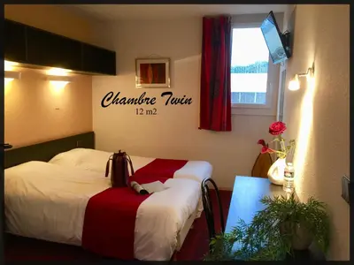 Un ou plusieurs lits dans un hébergement de l'établissement Hôtel du Parc Limoges & Restaurant 