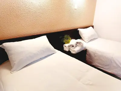 Un ou plusieurs lits dans un hébergement de l'établissement Hôtel du Parc Limoges & Restaurant 