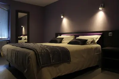 Un ou plusieurs lits dans un hébergement de l'établissement Logis Central Hôtel - Restaurant & Spa