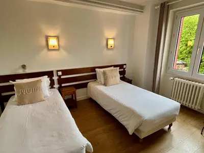 Un ou plusieurs lits dans un hébergement de l'établissement Hotel Restaurant Le Clos