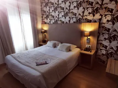 Un ou plusieurs lits dans un hébergement de l'établissement Grand Hôtel Brive