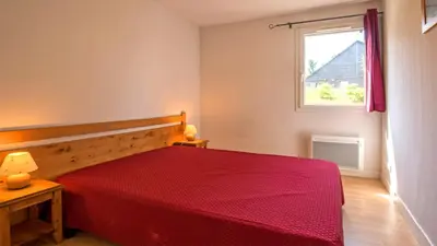 Un ou plusieurs lits dans un hébergement de l'établissement Vacancéole - Residence le Domaine du Bosquet