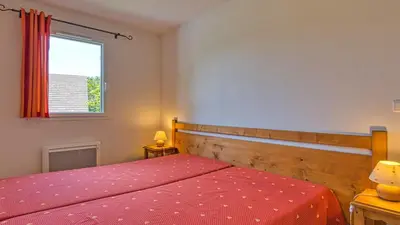 Un ou plusieurs lits dans un hébergement de l'établissement Vacancéole - Residence le Domaine du Bosquet