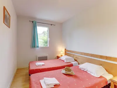 Un ou plusieurs lits dans un hébergement de l'établissement Vacancéole - Residence le Domaine du Bosquet