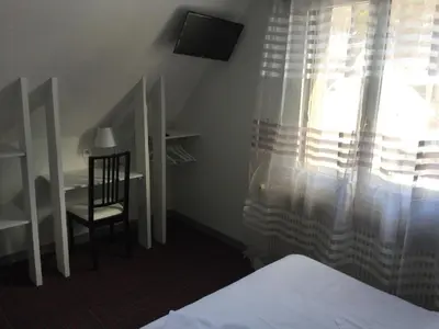 Un ou plusieurs lits dans un hébergement de l'établissement Auberge Le Cantou - Hôtel Roche