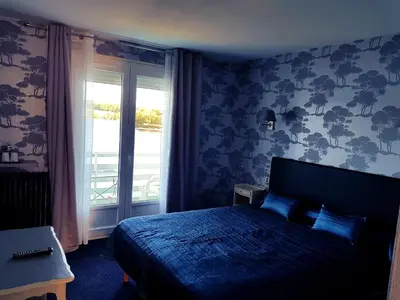 Un ou plusieurs lits dans un hébergement de l'établissement Hotel Restaurant La Caravelle