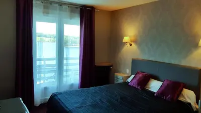 Un ou plusieurs lits dans un hébergement de l'établissement Hotel Restaurant La Caravelle