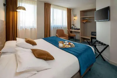 Un ou plusieurs lits dans un hébergement de l'établissement Best Western Hotel Le Quercy