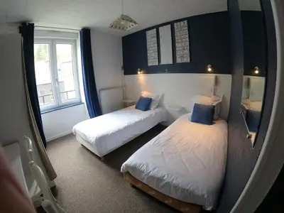 Un ou plusieurs lits dans un hébergement de l'établissement Hôtel de Londres