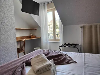Un ou plusieurs lits dans un hébergement de l'établissement Hotel Au Val Doré