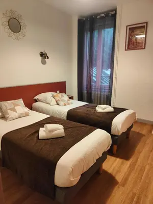 Un ou plusieurs lits dans un hébergement de l'établissement Hotel Au Val Doré