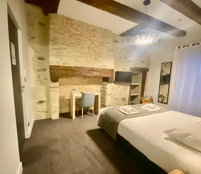 Un ou plusieurs lits dans un hébergement de l'établissement Hôtel Saint-Roch, Saint-Ybard