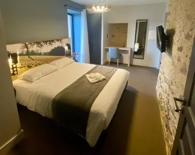 Un ou plusieurs lits dans un hébergement de l'établissement Hôtel Saint-Roch, Saint-Ybard