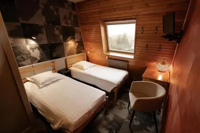 Un ou plusieurs lits dans un hébergement de l'établissement Gîte-Hôtel Le P'tit Cham