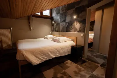 Un ou plusieurs lits dans un hébergement de l'établissement Gîte-Hôtel Le P'tit Cham