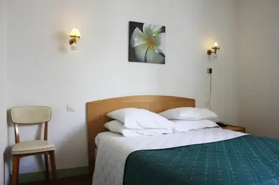 Un ou plusieurs lits dans un hébergement de l'établissement Hotel Le Chapitre