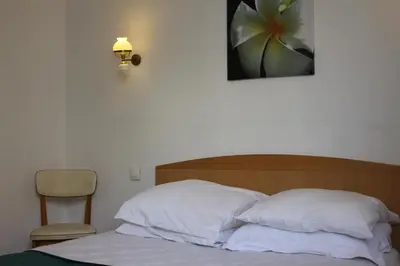 Un ou plusieurs lits dans un hébergement de l'établissement Hotel Le Chapitre