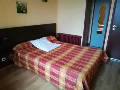 Un ou plusieurs lits dans un hébergement de l'établissement Hôtel de la Poste
