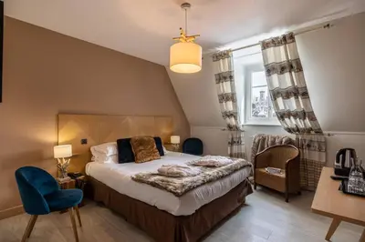 Un ou plusieurs lits dans un hébergement de l'établissement Le Bailliage Hôtel & Spa