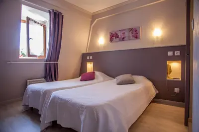 Un ou plusieurs lits dans un hébergement de l'établissement Logis Hotels - Auberge de l'Île - Hôtel 3 étoiles et Restaurant