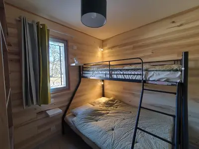 Un ou plusieurs lits dans un hébergement de l'établissement VILLAGE DE GITES LA TRUFFIERE