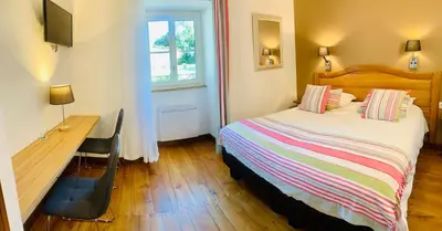 Un ou plusieurs lits dans un hébergement de l'établissement Hôtel Le Troubadour à Rocamadour