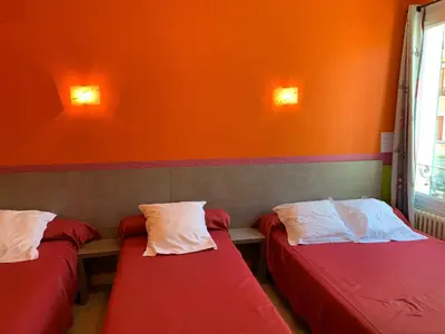 Un ou plusieurs lits dans un hébergement de l'établissement Hotel des voyageurs Chez Betty