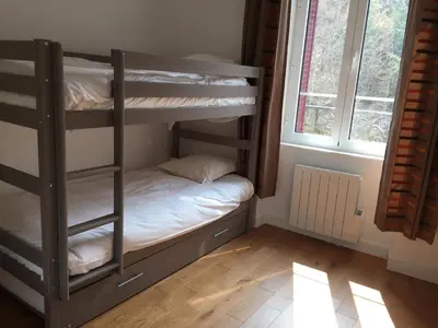 Un ou plusieurs lits dans un hébergement de l'établissement Magnifique et lumineux appartement au cœur du Sancy
