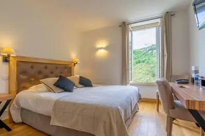 Un ou plusieurs lits dans un hébergement de l'établissement Hotel Beau Site - Rocamadour