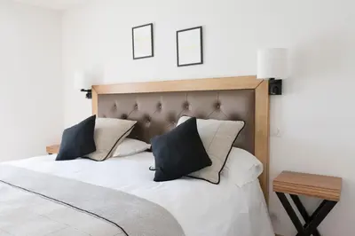 Un ou plusieurs lits dans un hébergement de l'établissement Hotel Beau Site - Rocamadour