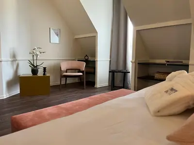 Un ou plusieurs lits dans un hébergement de l'établissement Hôtel La Truffe Noire