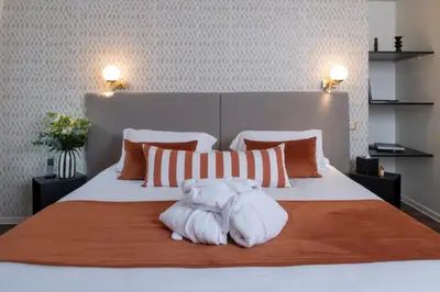 Un ou plusieurs lits dans un hébergement de l'établissement Hôtel La Truffe Noire