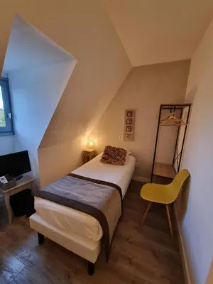 Un ou plusieurs lits dans un hébergement de l'établissement Amadour Hôtel