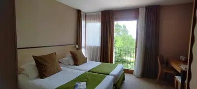 Un ou plusieurs lits dans un hébergement de l'établissement Hôtel Les Esclargies