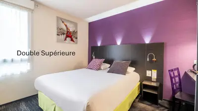 Un ou plusieurs lits dans un hébergement de l'établissement Kyriad Direct Limoges Nord