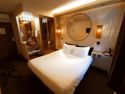 Un ou plusieurs lits dans un hébergement de l'établissement Hôtel Kyriad Brive Ouest