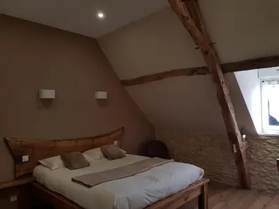 Un ou plusieurs lits dans un hébergement de l'établissement L'étable gourmande chambres d'hôtes et ferme auberge