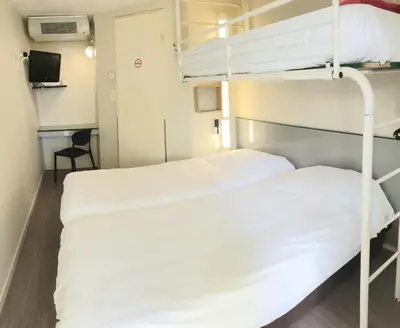 Un ou plusieurs lits dans un hébergement de l'établissement Premiere Classe Brive La Gaillarde Ouest