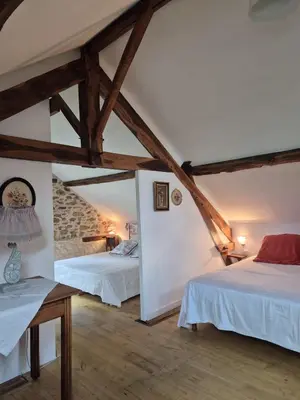Un ou plusieurs lits dans un hébergement de l'établissement Gîte le pré des Colombes