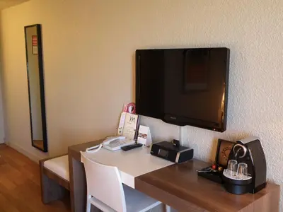 Télévision ou salle de divertissement dans l'établissement Mercure Brive