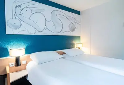Un ou plusieurs lits dans un hébergement de l'établissement B&B HOTEL Limoges 3