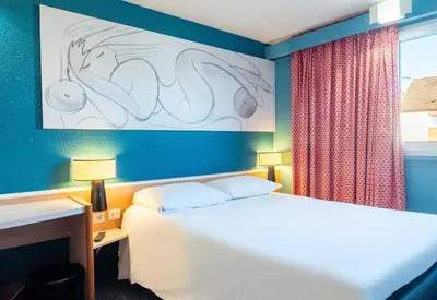 Un ou plusieurs lits dans un hébergement de l'établissement B&B HOTEL Limoges 3