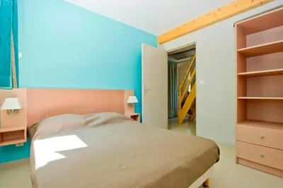 Un ou plusieurs lits dans un hébergement de l'établissement Résidence Goélia Les Cottages du Lac
