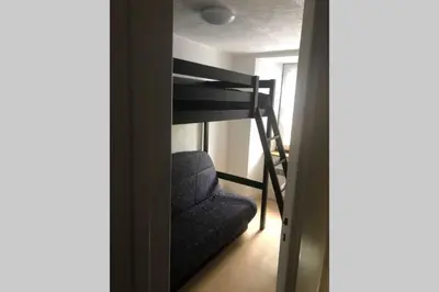 Un ou plusieurs lits dans un hébergement de l'établissement Joli appartement à Murat proche du Lioran Cantal