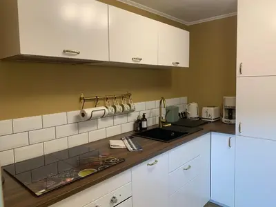 Cuisine ou kitchenette dans l'établissement La Rose des vents - Apparts plein centre ville