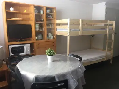 Un ou plusieurs lits dans un hébergement de l'établissement Studio Village des Longes