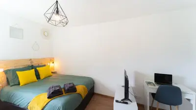 Un ou plusieurs lits dans un hébergement de l'établissement Cosy Apparts Brive