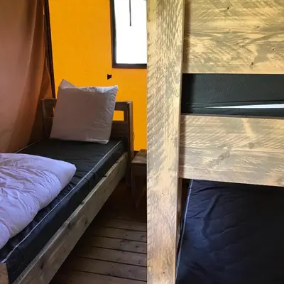 Un ou plusieurs lits dans un hébergement de l'établissement Camping Le Mondou
