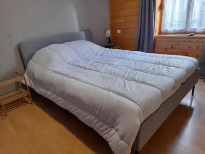 Un ou plusieurs lits dans un hébergement de l'établissement Agréable appartement de 48 m² en RDC